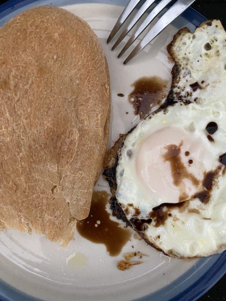 french bread with a fried egg and maggi sauce